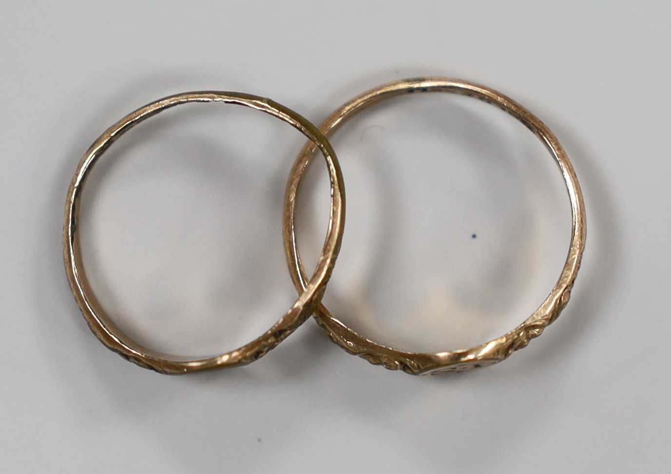 A pair of Georgian 'gold shell' child's rings, the rings heads with engraved initials, 'IS' and 'AS', sizes D/E and G.